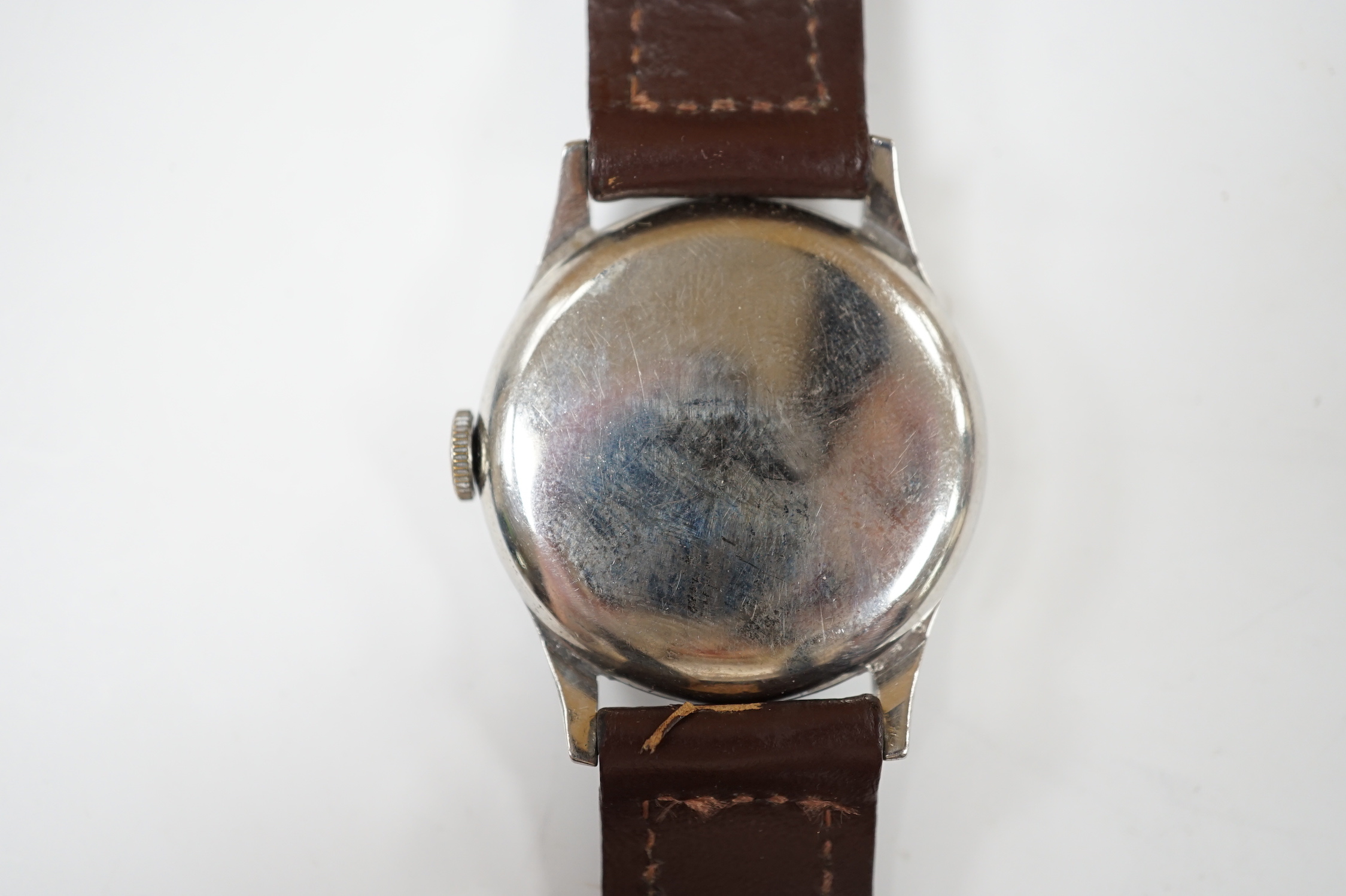 A gentleman's mid 20th century stainless steel Longines manual wind wrist watch, on associated leather strap, case diameter 34mm.